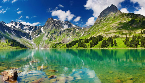 Body of water with mountains and trees Body of water with mountains and trees