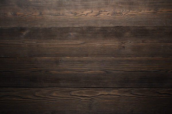 Dark wood surface with a few cracks Dark wood surface with a few cracks
