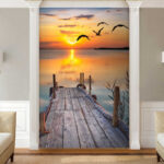 Wall murals Dock with birds flying over water