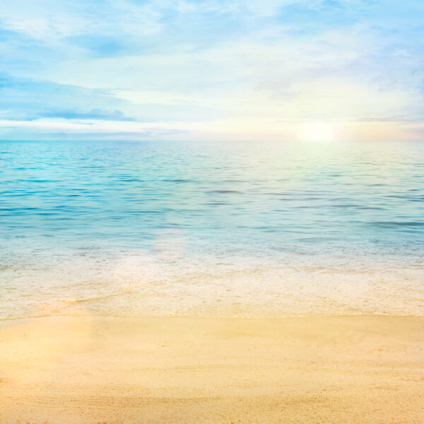 Sandy beach with blue water and a blue sky Sandy beach with blue water and a blue sky