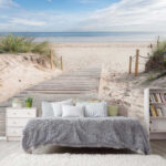 Wall mural Wooden walkway leading to a beach