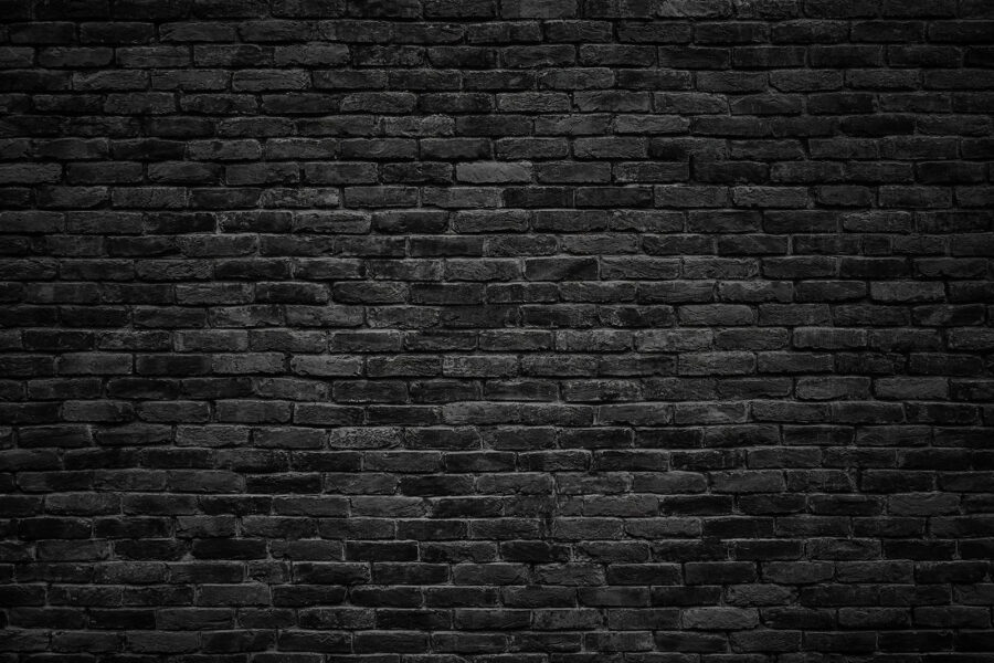Black brick wall with a white spot