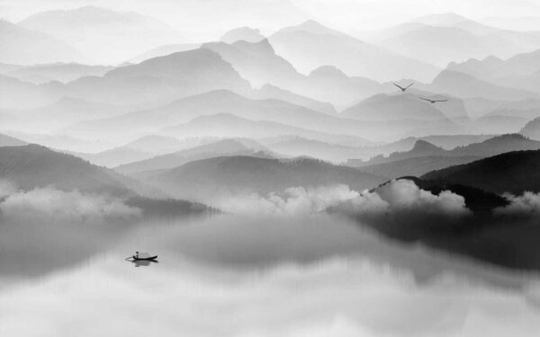Boat on a lake with mountains in the background Boat on a lake with mountains in the background