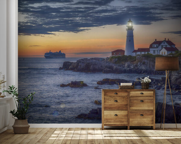 Lighthouse on a rocky shore with a cruise ship in the background