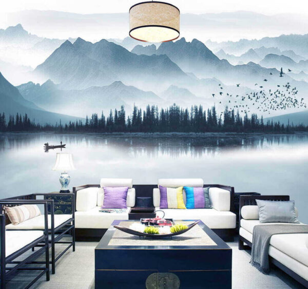 Person in a boat on a lake with mountains in the background Person in a boat on a lake with mountains in the background