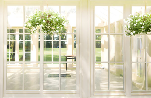 White patio door with glass windows and a potted plant from it u52614p 600x390 - White patio door with glass windows and a potted plant from it
