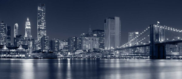 City skyline at night with a bridge over water City skyline at night with a bridge over water