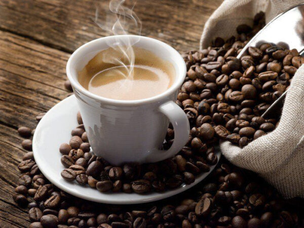 Cup of coffee on a saucer with coffee beans Cup of coffee on a saucer with coffee beans