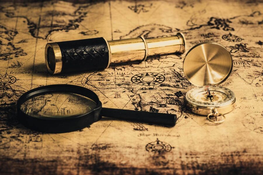 Magnifying glass and a telescope on a map