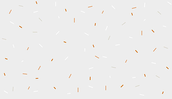 A white and orange sprinkles on a gray background A white and orange sprinkles on a gray background