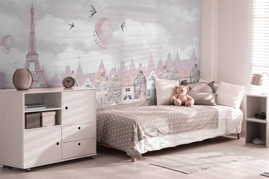 Pink and white cityscape with pink balloons and birds flying