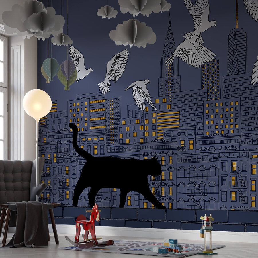 Cat walking on a wall with birds flying in the sky